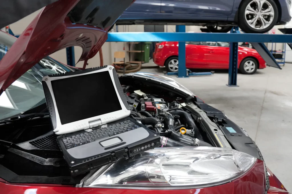 car-in-a-workshop-and-a-computer-running-diagnosti-2023-11-27-05-04-53-utc-1024x681